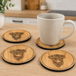 White mug on wooden coasters with highland cow design in a kitchen setting