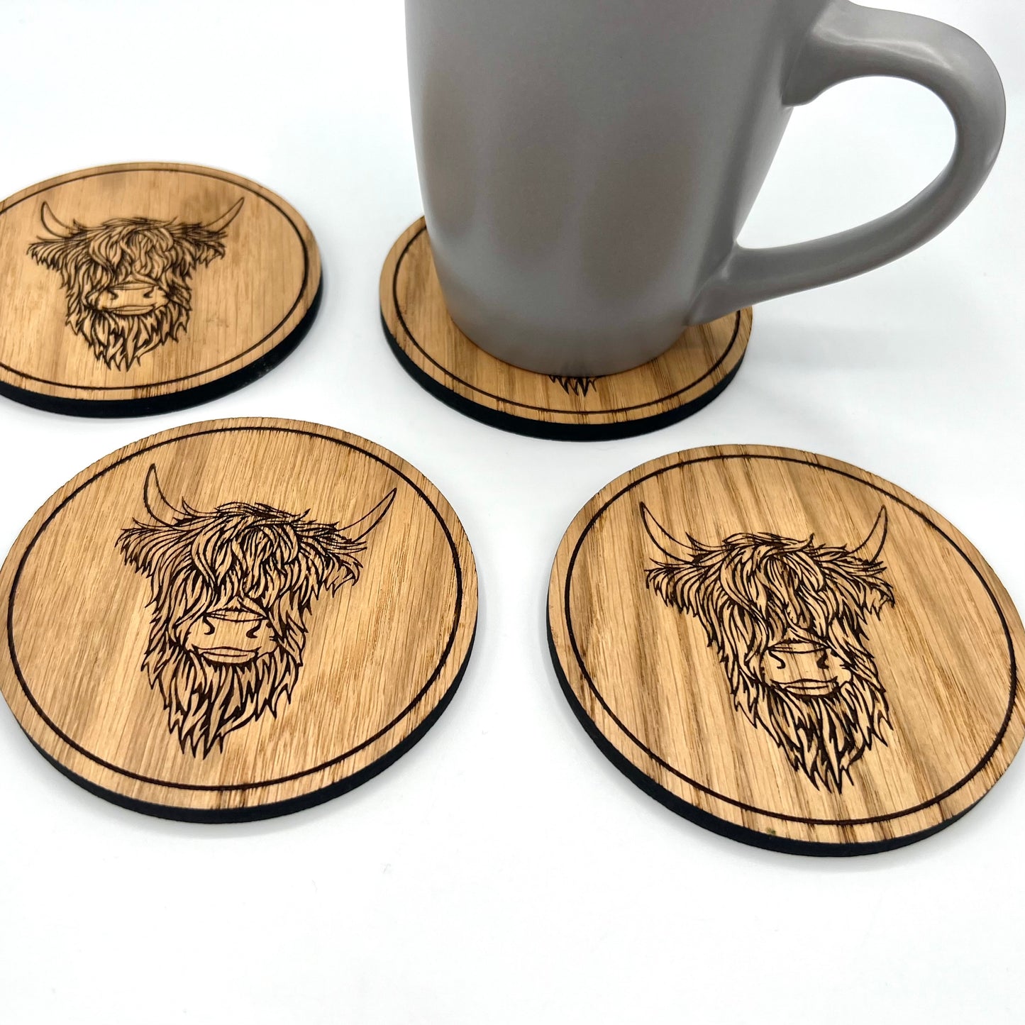 Coffee mug placed on Highland Cow wooden coaster