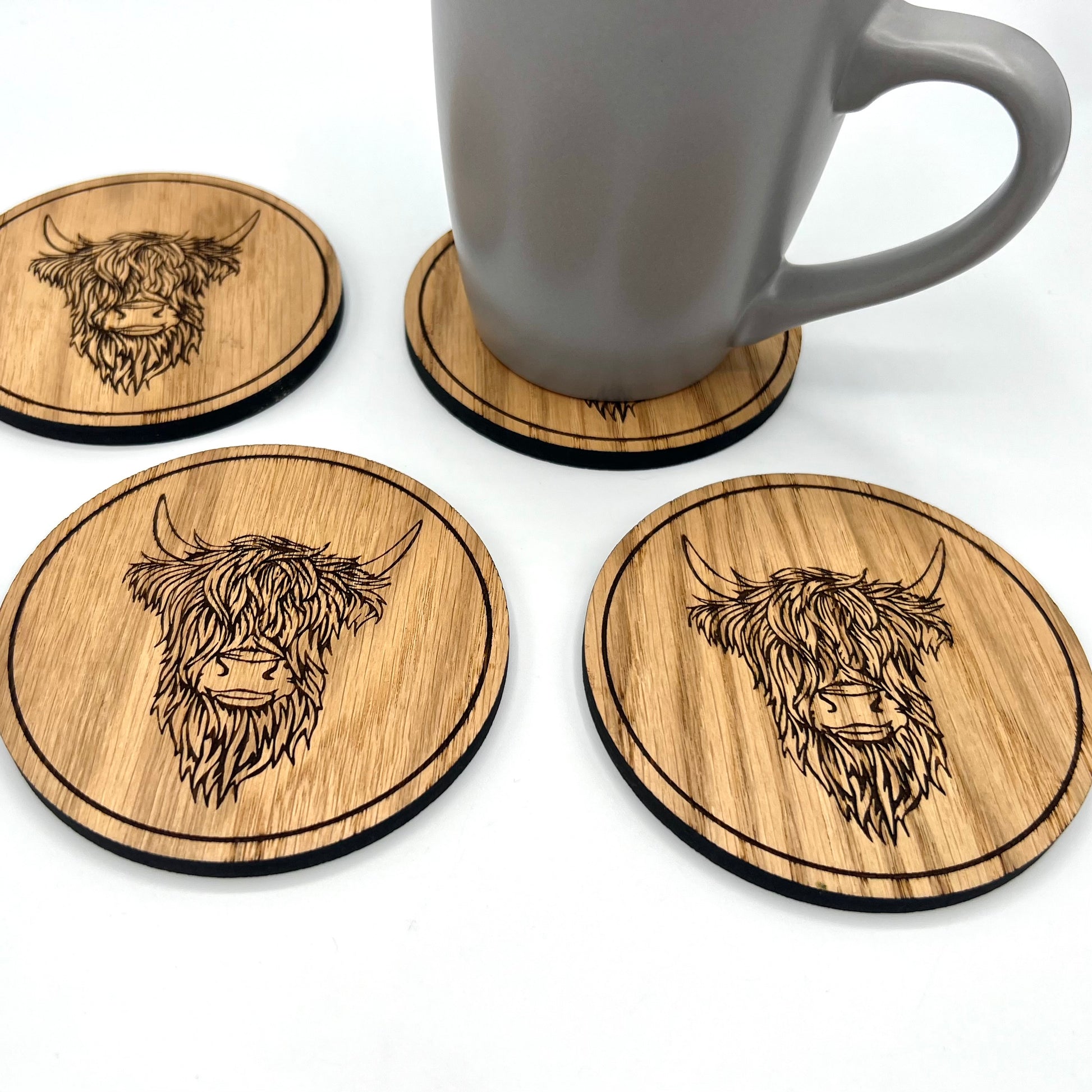 Coffee mug placed on Highland Cow wooden coaster