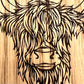 Close up of laser engraved Highland Cow coaster design