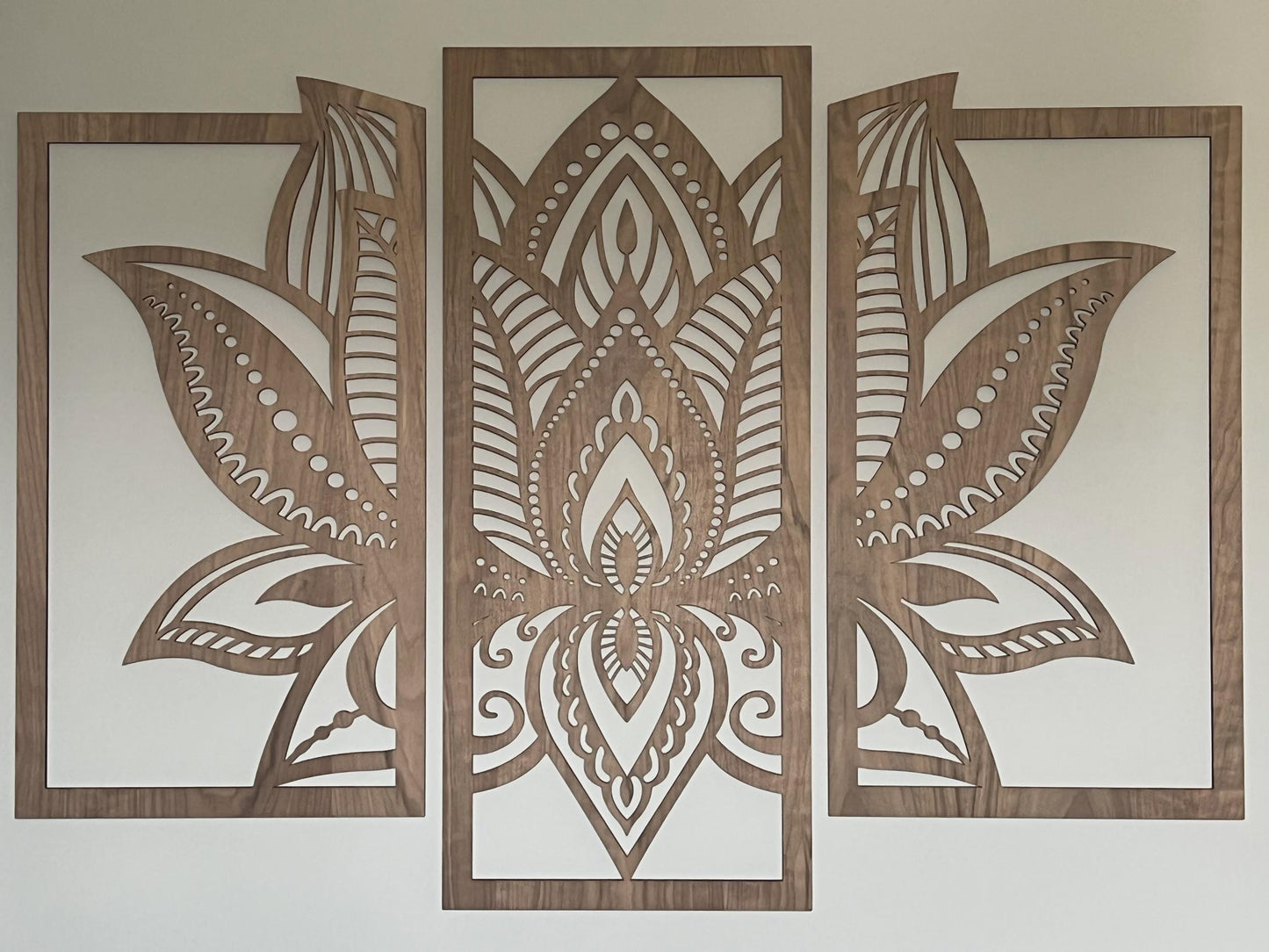 3 panels of wooden wall art cut in walcut veneer wood hanging on a cream wall
