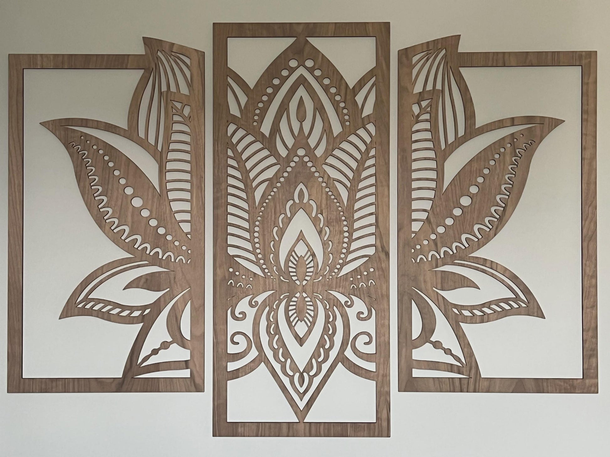 3 panels of wooden wall art cut in walcut veneer wood hanging on a cream wall
