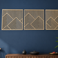 Three geometric mountains wall art piece on a blue wall with a wooden console table and plant.
