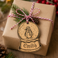 Personalised Wooden penguin snow globe gift tag attached to Christmas present