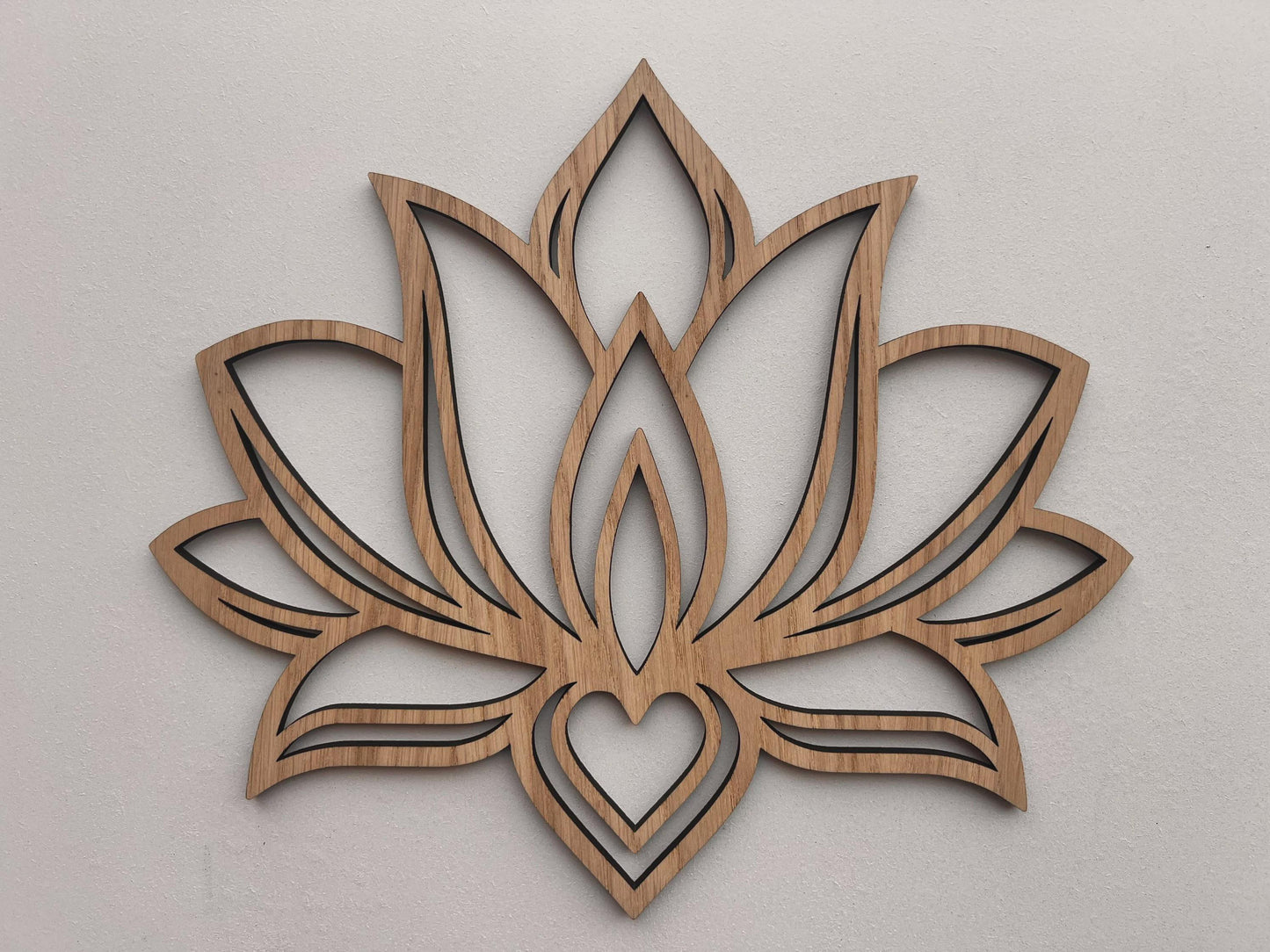 Wooden lotus flower wall decor on a light gray background