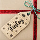 Custom wooden Christmas name tags attached to presents